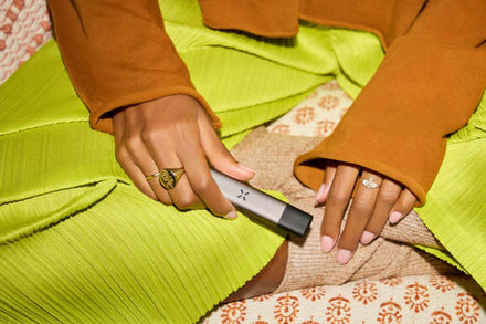 Someone holding a PAX ERA vape pen with a pod inserted