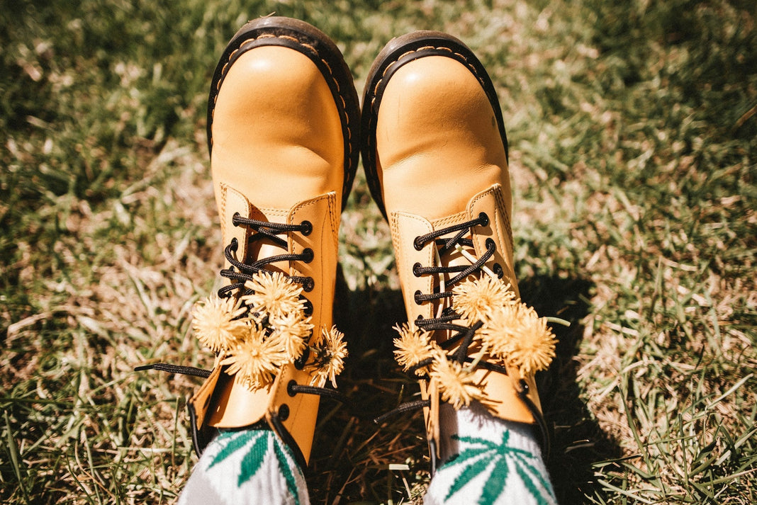 Woman's boots in spring time outside with cannabis leaf socks