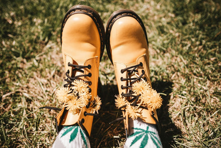 Woman's boots in spring time outside with cannabis leaf socks