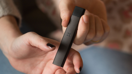 Hands holding a PAX Pod