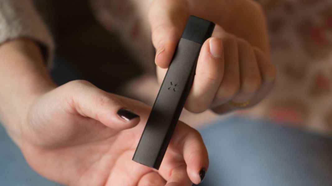 Hands holding a PAX ERA device