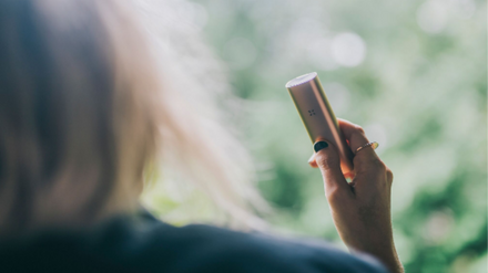 Woman using PAX 3 dry herb vaporizer