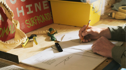 Person writing at desk with PAX Pod sitting on desk