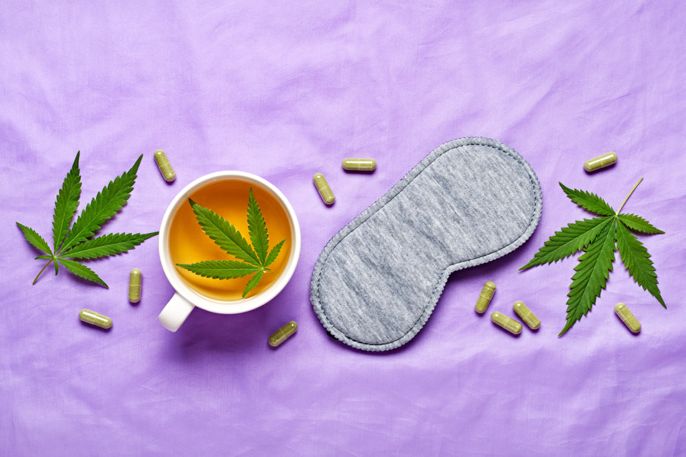 Sleep mask alongside cannabis leaves