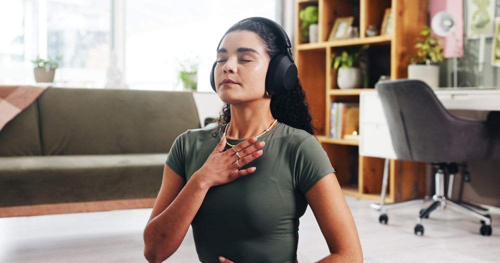 Woman doing mindful breathing with headphones